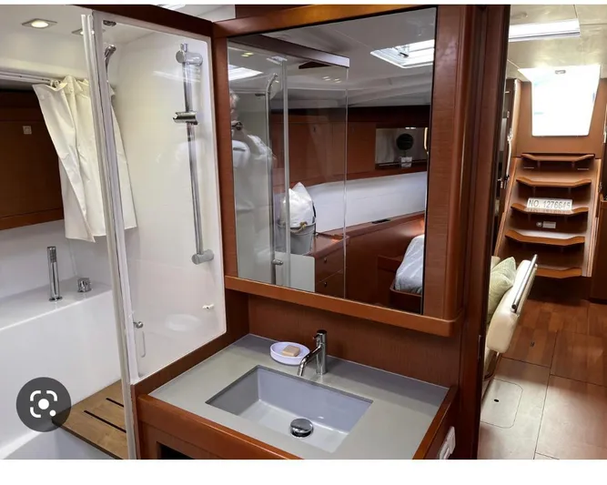  Yacht Photos Pics Interior of 2014 Beneteau Oceanis 48 yacht, featuring a modern bathroom and wooden finishes.