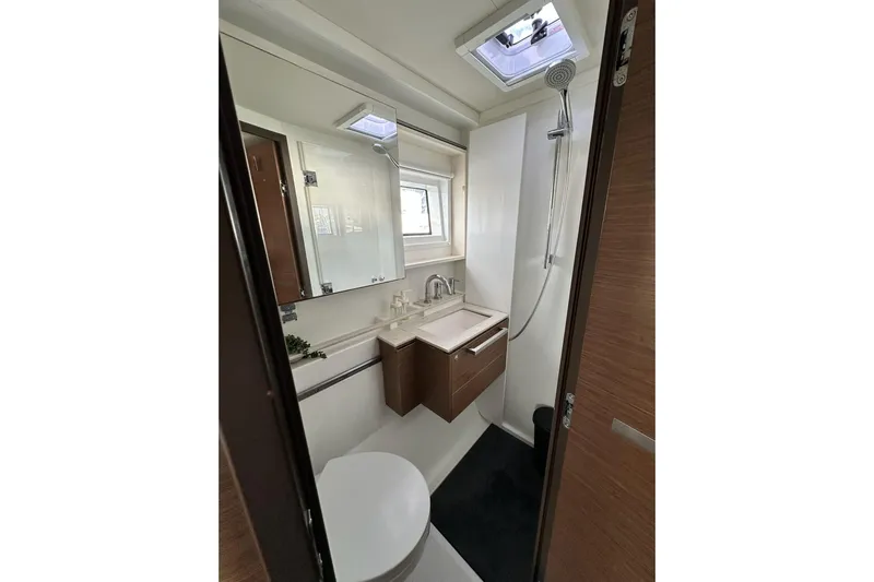 Buena Vida Yacht Photos Pics Modern bathroom in 2023 Lagoon 50 yacht with shower, sink, and mirror.