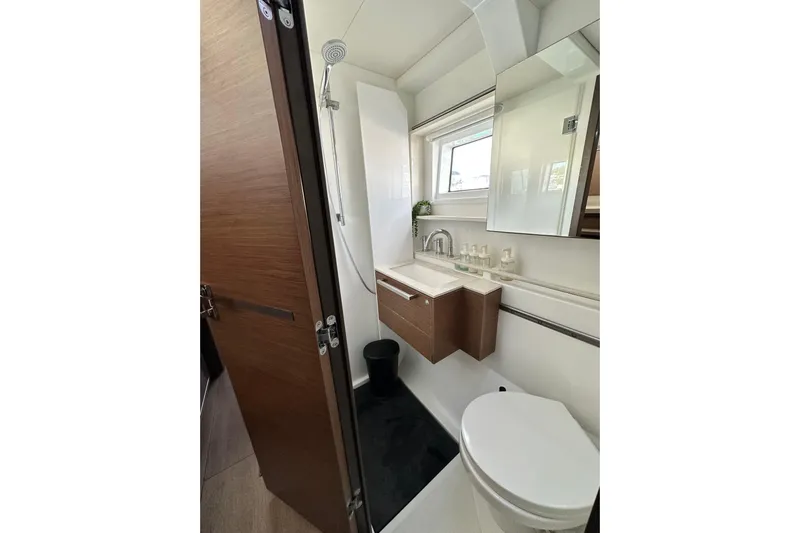 Buena Vida Yacht Photos Pics Modern bathroom in 2023 Lagoon 50 yacht with sleek fixtures and wooden accents.