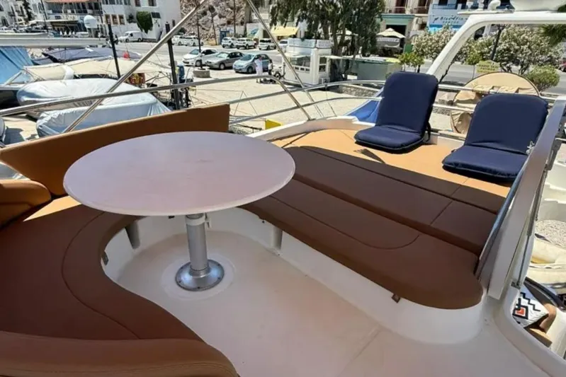  Yacht Photos Pics Luxurious seating area on 2005 Jeanneau Prestige 46 yacht with round table and cushions.
