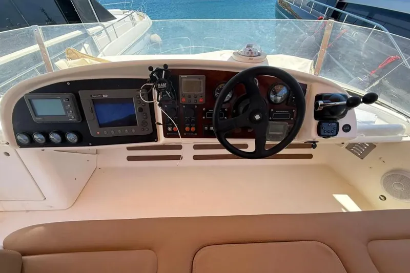  Yacht Photos Pics Helm of 2005 Jeanneau Prestige 46 yacht with navigation instruments and steering wheel.