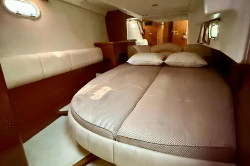  Yacht Photos Pics Luxurious cabin interior of 2005 Jeanneau Prestige 46 yacht with cozy bedding.