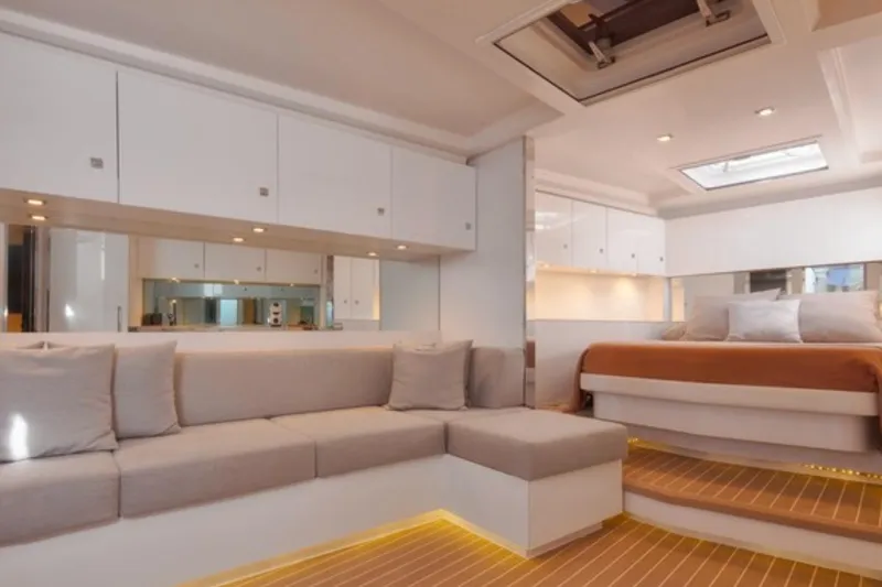Sin Nombre Yacht Photos Pics Luxurious interior of 2012 VanDutch 55 yacht with modern seating and elegant bedroom.