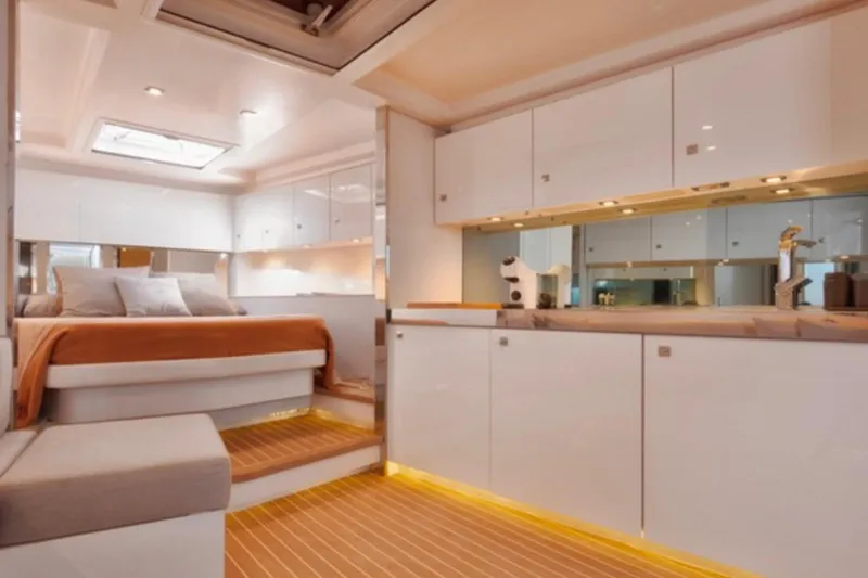 Sin Nombre Yacht Photos Pics Luxurious interior of 2012 VanDutch 55 yacht with modern kitchen and cozy bedroom.