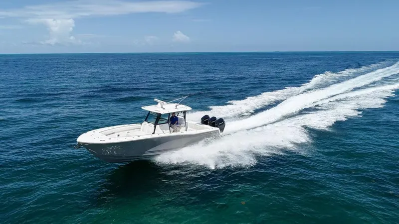  Yacht Photos Pics 2025 Caymas 341 CC boat cruising on open ocean under clear blue sky.