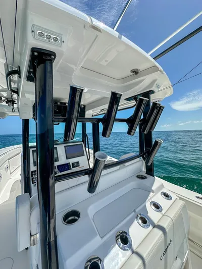  Yacht Photos Pics 2025 Caymas 341 CC boat interior with rod holders, ocean view, and clear blue sky.