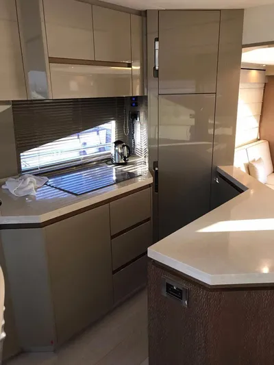 Yacht Photos Pics Modern kitchen interior of 2014 Dominator 640 S yacht with sleek cabinetry and countertops.