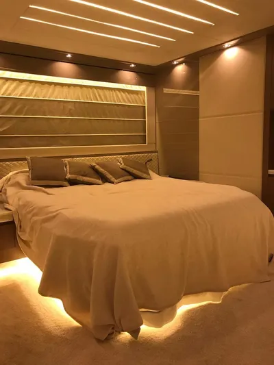  Yacht Photos Pics Luxurious bedroom interior in 2014 Dominator 640 S yacht, featuring ambient lighting and elegant decor.