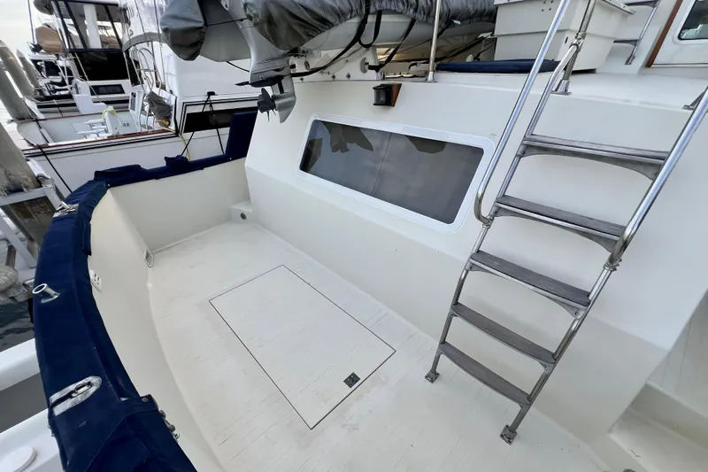 Adios Yacht Photos Pics 1985 Tollycraft 48 Cockpit Motor Yacht with ladder and spacious deck area.