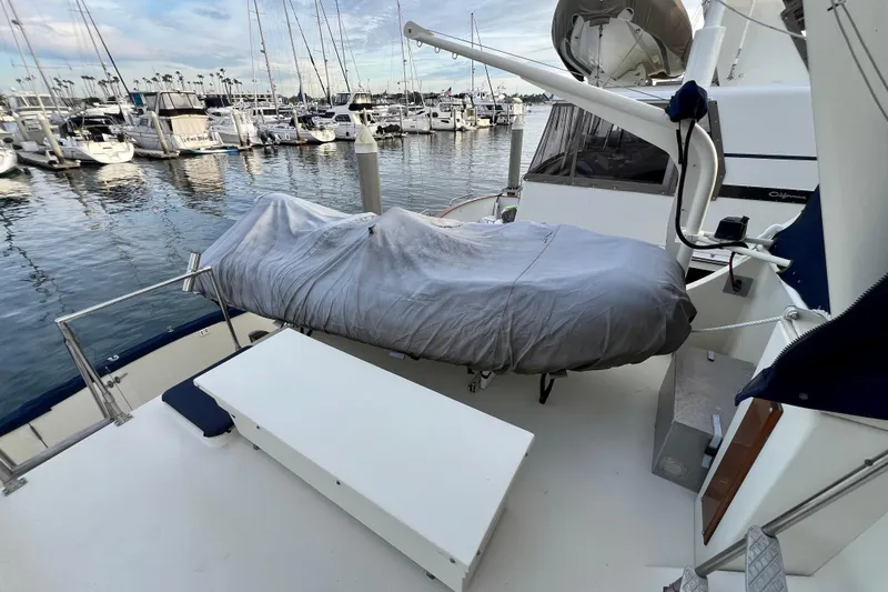Adios Yacht Photos Pics 1985 Tollycraft 48 Cockpit Motor Yacht docked, featuring covered equipment and marina view.