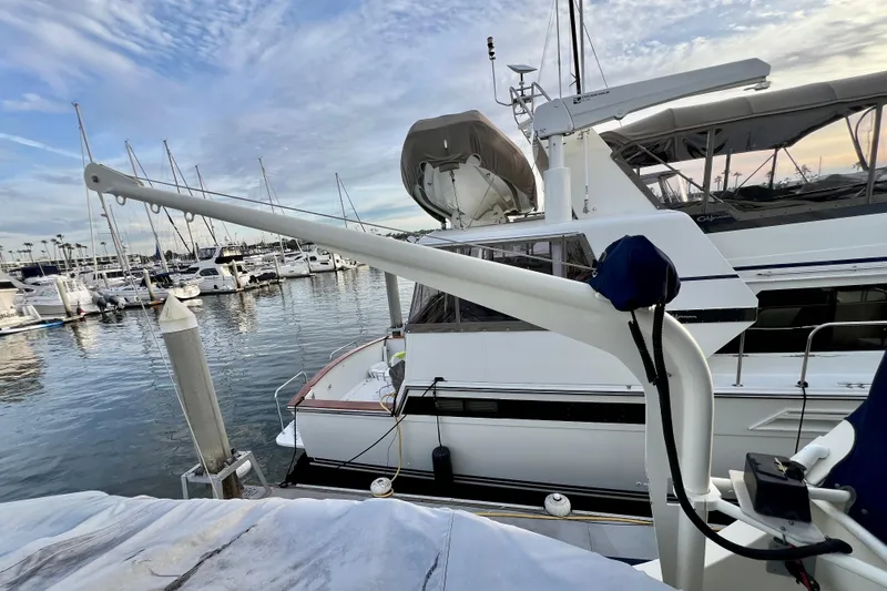 Adios Yacht Photos Pics 1985 Tollycraft 48 Cockpit Motor Yacht docked at marina, surrounded by other boats.