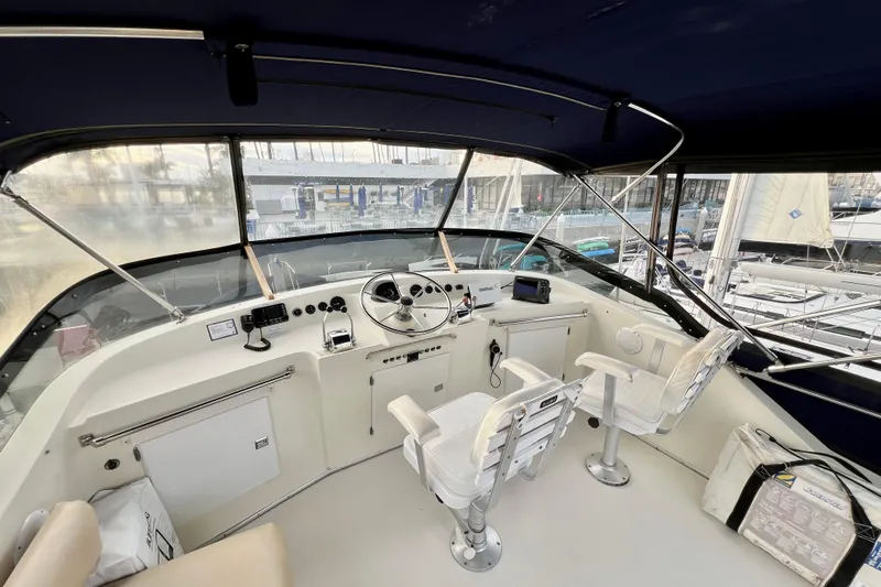 Adios Yacht Photos Pics 1985 Tollycraft 48 Cockpit Motor Yacht helm with steering wheel and navigation equipment.