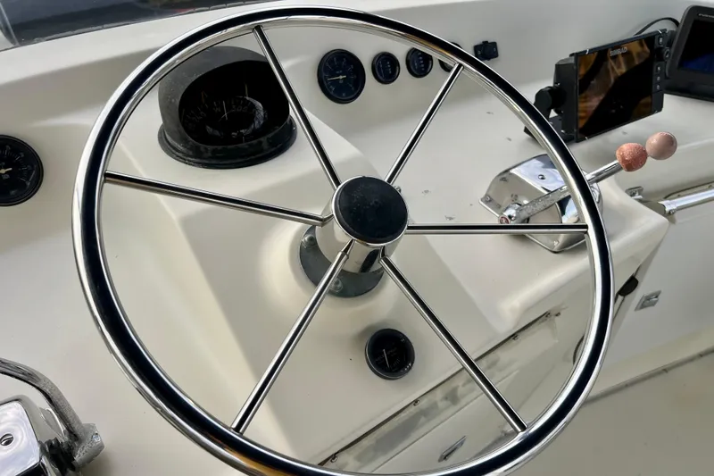 Adios Yacht Photos Pics Steering wheel and controls of 1985 Tollycraft 48 Cockpit Motor Yacht.