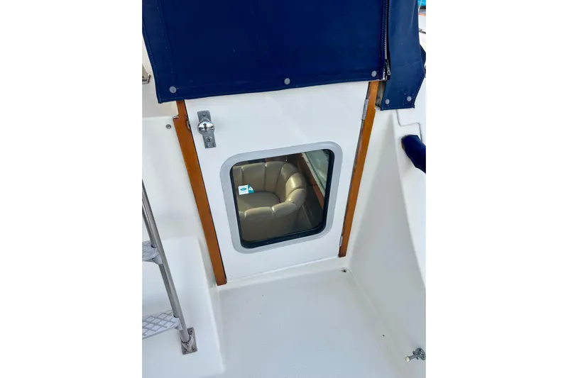 Adios Yacht Photos Pics 1985 Tollycraft 48 Cockpit Motor Yacht door with window and blue cover.