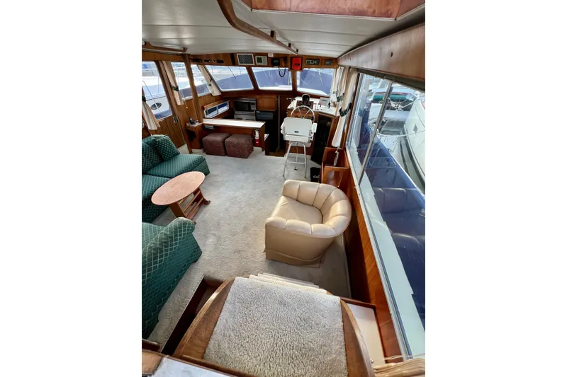 Adios Yacht Photos Pics Interior of 1985 Tollycraft 48 Cockpit Motor Yacht with plush seating and helm station.