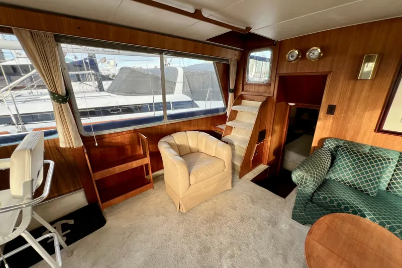 Adios Yacht Photos Pics Interior of 1985 Tollycraft 48 Cockpit Motor Yacht with seating and wood paneling.