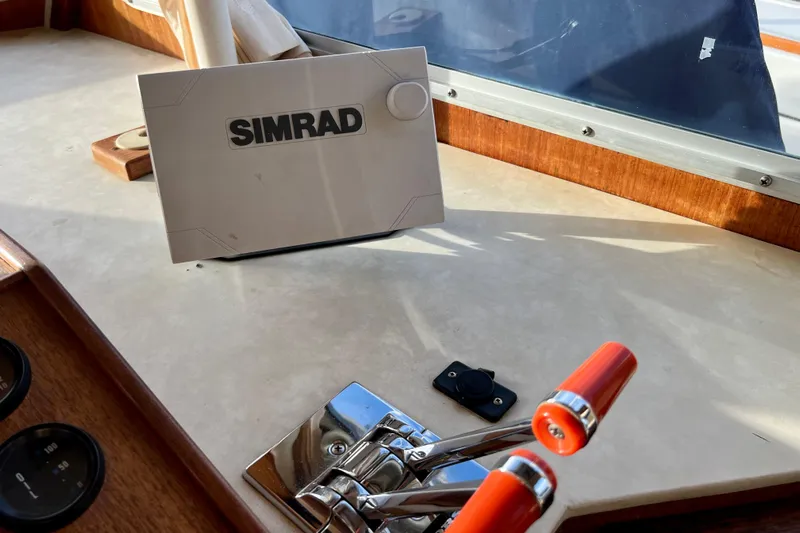 Adios Yacht Photos Pics Control panel of 1985 Tollycraft 48 Cockpit Motor Yacht with Simrad navigation system.