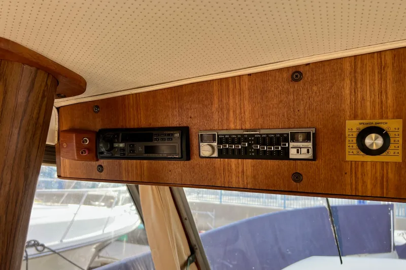 Adios Yacht Photos Pics 1985 Tollycraft 48 Cockpit Motor Yacht interior with vintage audio controls.