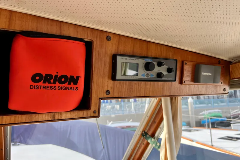 Adios Yacht Photos Pics 1985 Tollycraft 48 Cockpit Motor Yacht interior with Orion distress signals and navigation equipment.