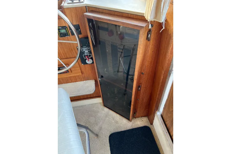 Adios Yacht Photos Pics 1985 Tollycraft 48 Cockpit Motor Yacht helm with wooden paneling and steering wheel.