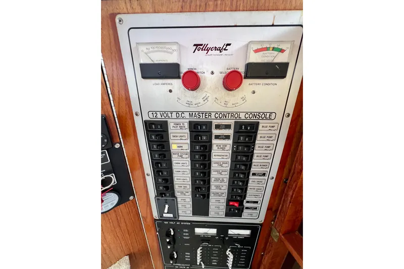 Adios Yacht Photos Pics Control panel of 1985 Tollycraft 48 Cockpit Motor Yacht, featuring 12-volt DC master console.
