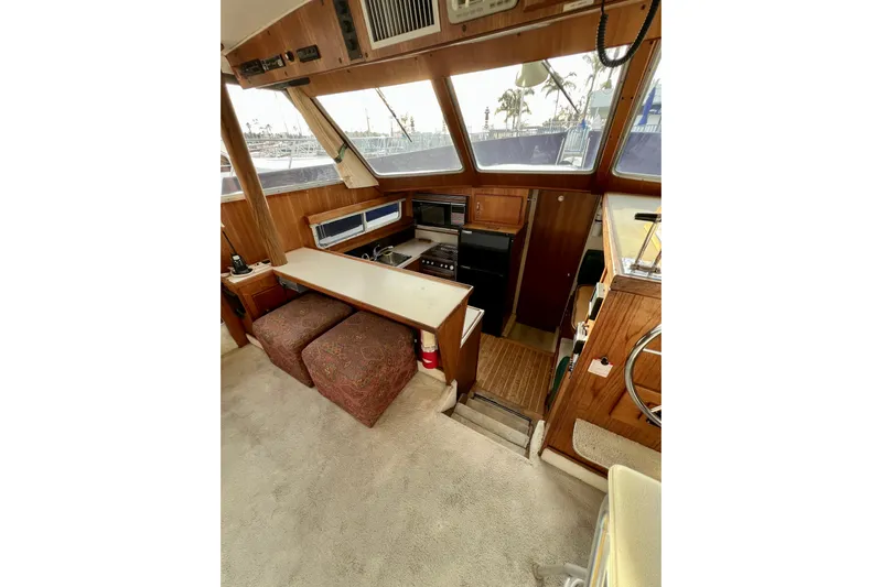 Adios Yacht Photos Pics 1985 Tollycraft 48 Cockpit Motor Yacht interior with helm, seating, and navigation equipment.
