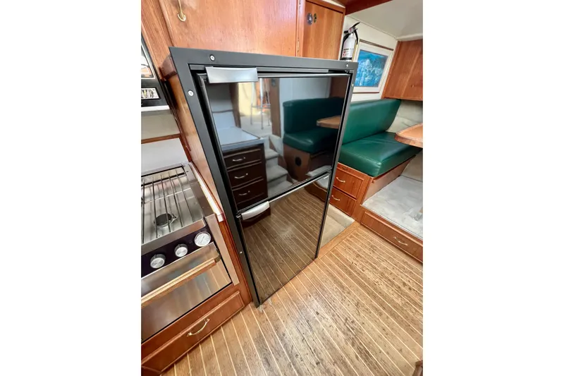 Adios Yacht Photos Pics 1985 Tollycraft 48 Cockpit Motor Yacht interior with kitchen and dining area.