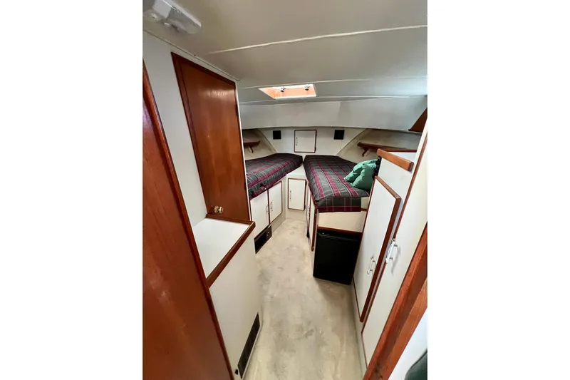 Adios Yacht Photos Pics 1985 Tollycraft 48 Cockpit Motor Yacht interior cabin with twin beds and wood accents.