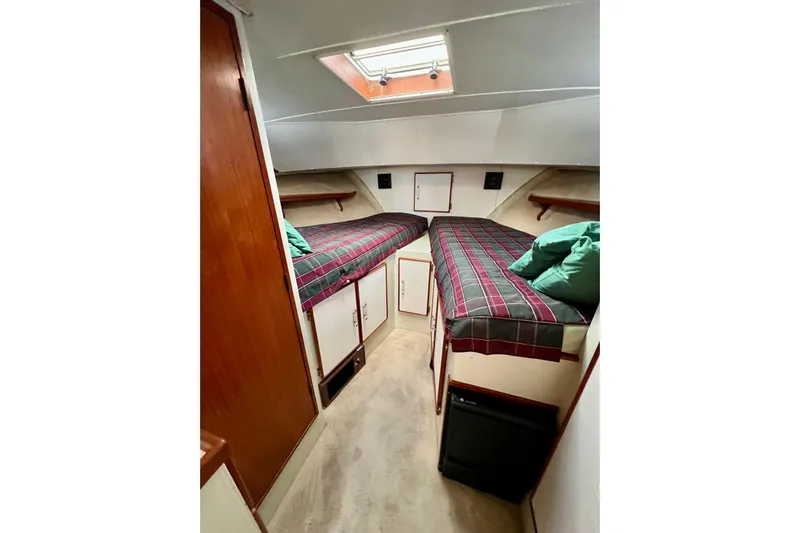 Adios Yacht Photos Pics 1985 Tollycraft 48 Cockpit Motor Yacht cabin with twin beds and overhead skylight.