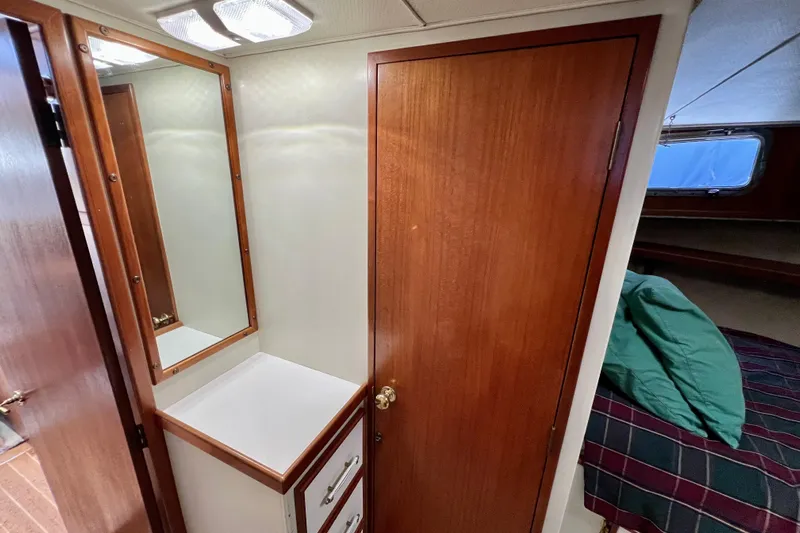 Adios Yacht Photos Pics 1985 Tollycraft 48 Cockpit Motor Yacht interior with wood cabinetry and mirror.
