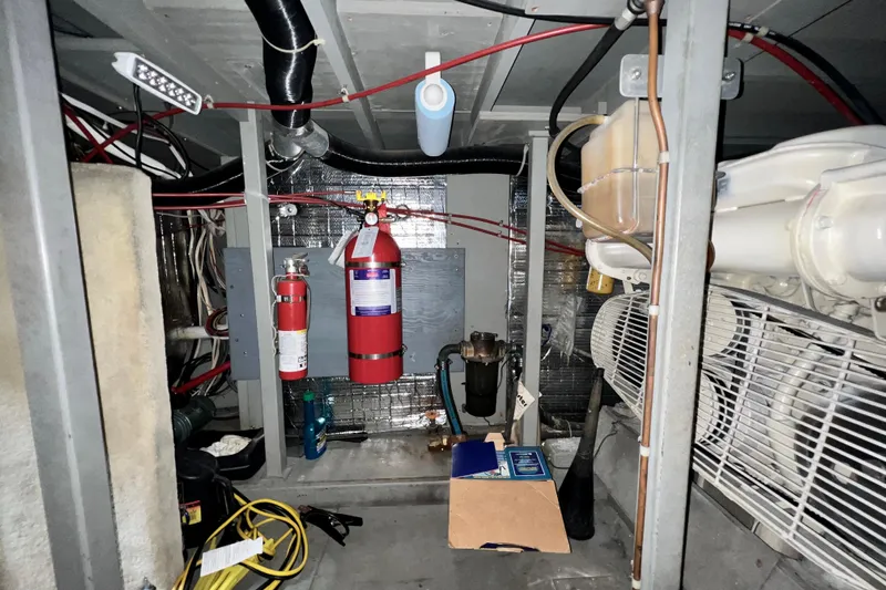 Adios Yacht Photos Pics Engine room of 1985 Tollycraft 48 Cockpit Motor Yacht with fire extinguishers and wiring.