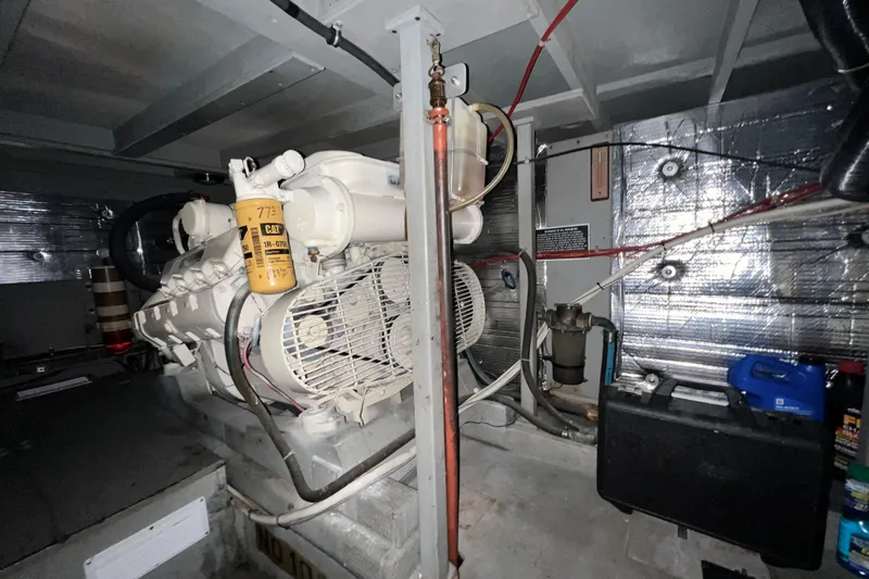 Adios Yacht Photos Pics Engine room of 1985 Tollycraft 48 Cockpit Motor Yacht with visible machinery and equipment.