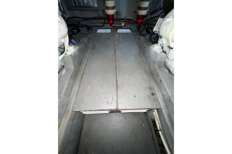 Adios Yacht Photos Pics Engine room of 1985 Tollycraft 48 Cockpit Motor Yacht, featuring mechanical components.