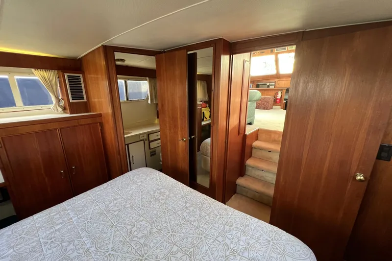 Adios Yacht Photos Pics Interior of 1985 Tollycraft 48 Cockpit Motor Yacht with wood paneling and cozy furnishings.