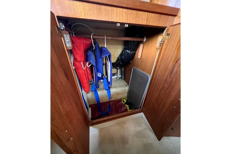Adios Yacht Photos Pics Storage cabinet on 1985 Tollycraft 48 Cockpit Motor Yacht with life jackets and equipment.