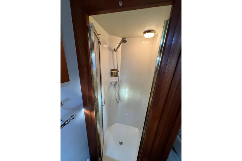 Adios Yacht Photos Pics Shower area in 1985 Tollycraft 48 Cockpit Motor Yacht with wooden trim.
