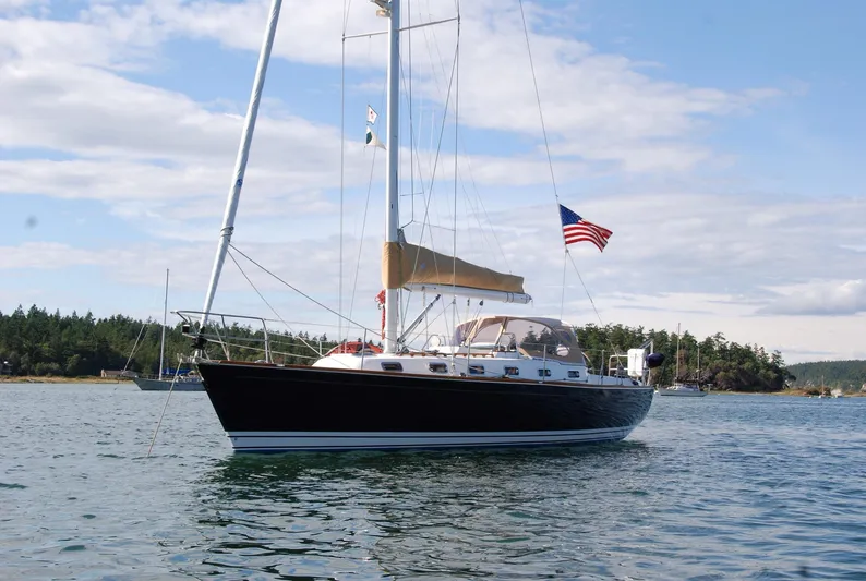 Chance Yacht Photos Pics Sailboat Tartan 4100 (1999) on calm water with American flag, scenic background.