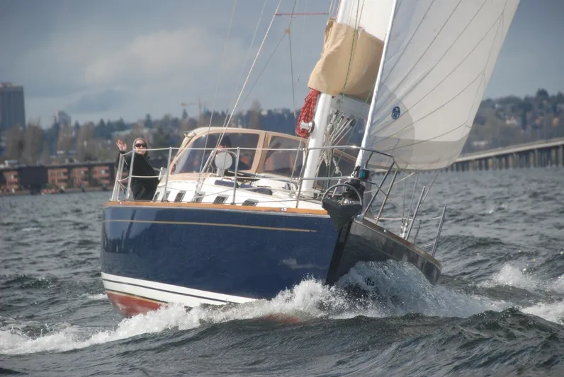 Chance Yacht Photos Pics Sailing yacht Tartan 4100 (1999) navigating choppy waters near a coastal city.