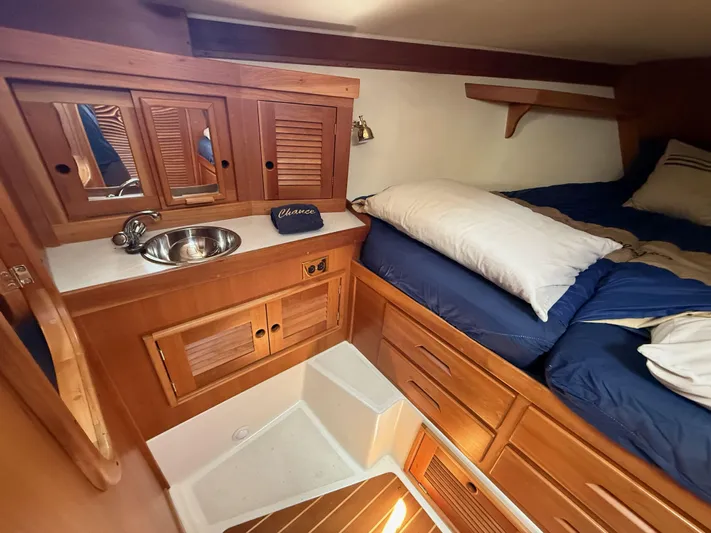 Chance Yacht Photos Pics Cozy cabin interior of 1999 Tartan 4100 sailboat with wooden cabinetry and bed.