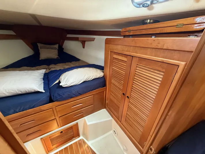 Chance Yacht Photos Pics Cozy cabin interior of 1999 Tartan 4100 sailboat with wooden storage and bedding.