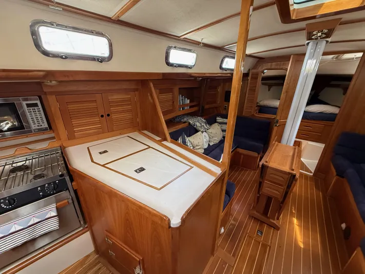 Chance Yacht Photos Pics Interior of a 1999 Tartan 4100 sailboat with wood finish and cozy seating.