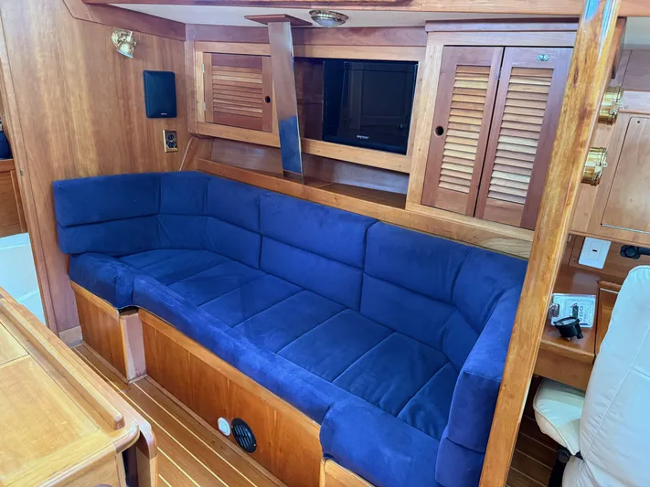 Chance Yacht Photos Pics Luxurious interior of 1999 Tartan 4100 yacht with blue cushioned seating.