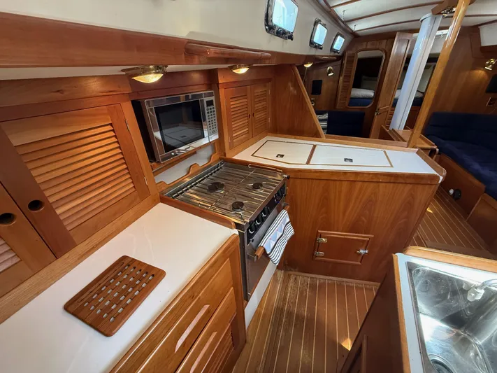 Chance Yacht Photos Pics Interior of 1999 Tartan 4100 yacht with wooden cabinetry and modern kitchen amenities.