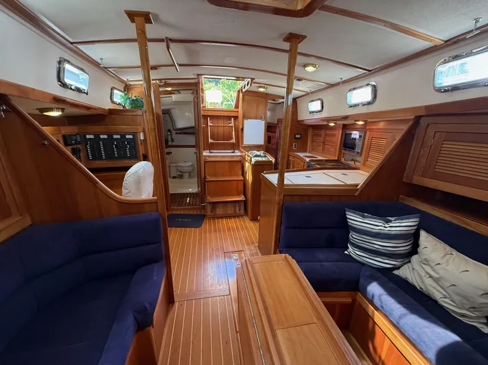 Chance Yacht Photos Pics Interior of 1999 Tartan 4100 sailboat with wooden finish and blue seating.
