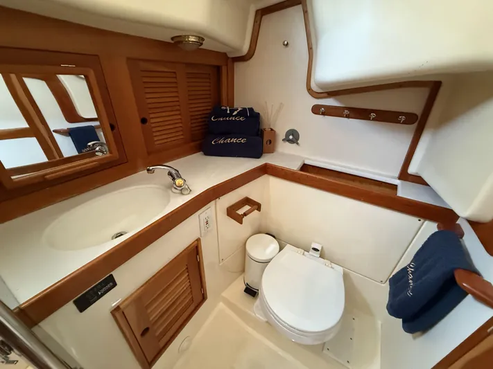 Chance Yacht Photos Pics 1999 Tartan 4100 yacht bathroom with wooden accents and modern fixtures.