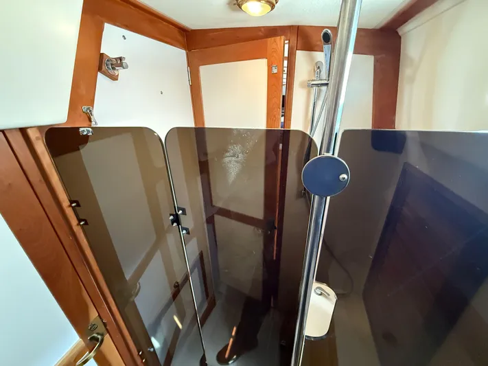 Chance Yacht Photos Pics Interior of 1999 Tartan 4100 sailboat with wooden finishes and modern shower area.