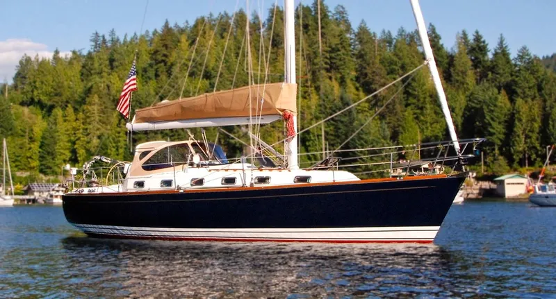 Chance Yacht Photos Pics Sailboat Tartan 4100, 1999 model, on a serene lake with forested background.