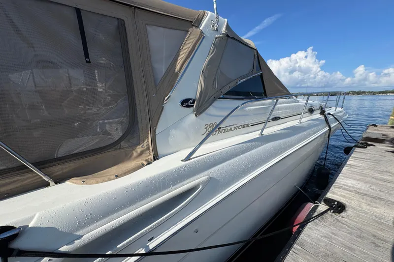 Solid Rock Yacht Photos Pics 2003 Sea Ray 380 Sundancer yacht docked, featuring sleek design and beige canopy.