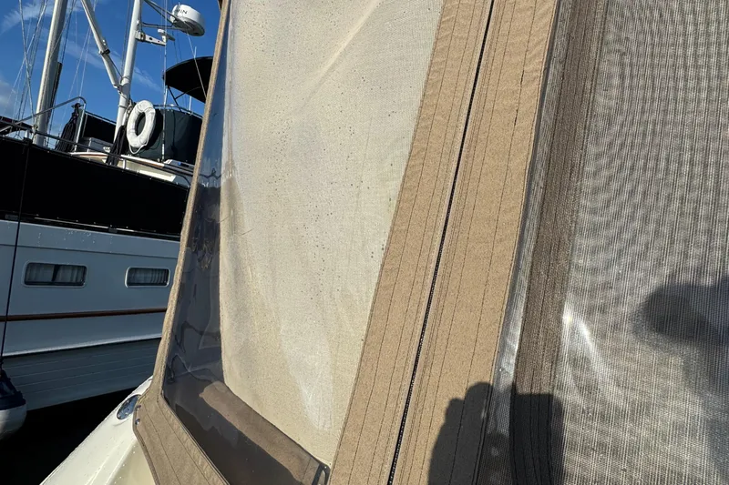 Solid Rock Yacht Photos Pics 2003 Sea Ray 380 Sundancer with beige canvas enclosure, docked near another boat.