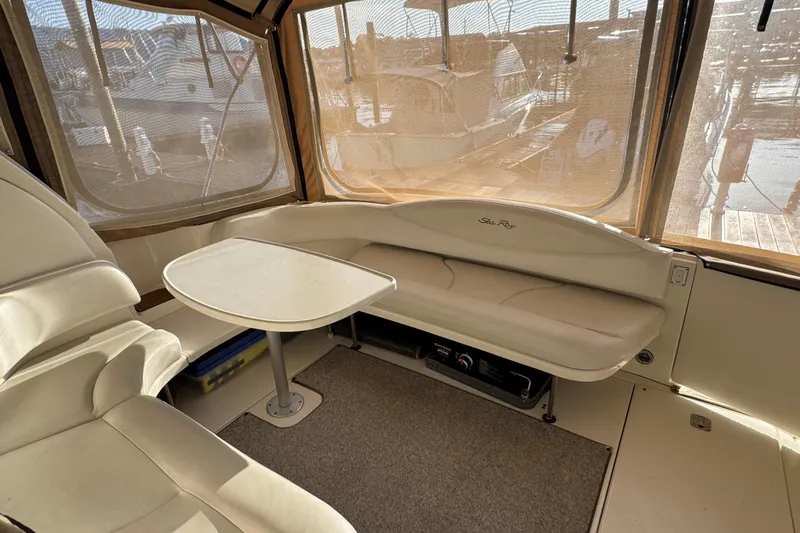 Solid Rock Yacht Photos Pics Interior of 2003 Sea Ray 380 Sundancer with seating and table, marina view.